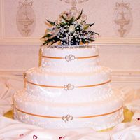 Ribbon & Charms Wedding Cake Simple wedding cake with random scrolls & dots in the design. Bride provided the entwined heart charms to add to the thin ribbon on the...