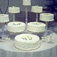 Floating Wedding Cake This cake is fun to make and easy to set up. Also different cakes are different flavors. Serving is also easier than a stacked cake.