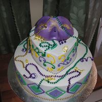 Mardi Gras Party Buttercream w/fondant decoration and gumpaste/fondant mask. Beads are non-edible.