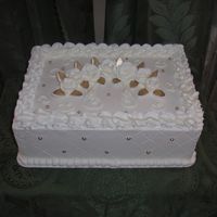 White Roses 1/4 sheet, french vanilla, buttercream, and gold dragees, and fondant leaves