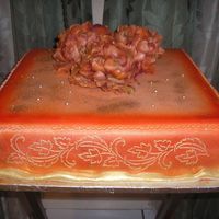 Orangie 16" inch square, fondant, airbrushed, gold sparkle dust, and silk flowers.