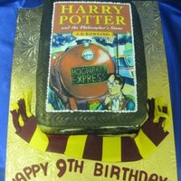Harry Potter Marble cake, buttercream filling, fondant finish with an ediable image for the cover. The scarf is also make of modeling paste