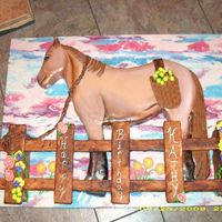 Horse Cake With Fence Horse is Dark Chocolate Fudge cake with buttercream icing covered with MMF. Fence is stryfoam covered with MMF and painted. I added flowers...