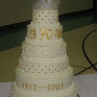 50Th Anniversary Cake Red Velvet, Carrot, and Italian Cream layers frosted and filled with BC. Monogram and dates are color flow painted with luster dust, and...