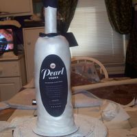 Pearl Vodka Bottle seven 4" rounds stacked. dowel rod thru center. pvc pipe for bottle neck. covered with fondant, airbrushed with pearl dust, edible...