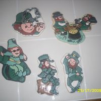 The Whole Leprechaun Gang Sugar cookies with royal icing. I think the leprechaun sliding down the shamrock looks like it joined the witness protection program, LOL...