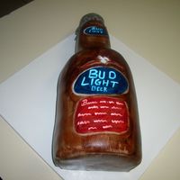Bud Light Beer cake made with 4 6" cakes, torted, filled and stacked. Cupcake covered in MMF for the bottle top.