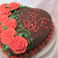 Valentine's Heart Cake Dark chocolate cake with chocolate fudge pudding filling covered in chocolate buttercream. Buttercream roses, leaves, vines and drop...