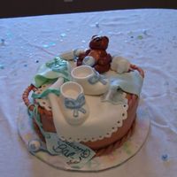 Basket Baby Shower Cake This is 3 12in cakes (vanilla, strawberry, vanilla) with cream cheese icing and covered in MMF. The bib, onesie, bear, and tag are MMF. The...
