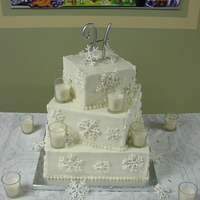 Sqaure Wedding Cake With Snowflakes FIRST 6, 9, 12 slightly twisted square wedding cake. All BC with RI snowflakes. Edible glitter on snowflakes and cake with luster dust on...