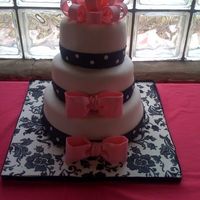 Bridal Shower Cake/black, White And Pink Color Scheme three tier, 10, 8, 6 covered in fondant. gumpaste bows and bow topper. board stenciled in royal icing