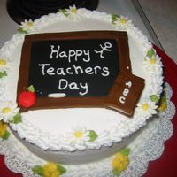 Teachers Day Cake Frosted with buttercream. Fondant chalk board, and book, royal icing flowers.
