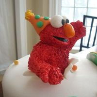 Close Up Of Elmo From Triplet Cake gumpaste elmo with a fondant party hat!