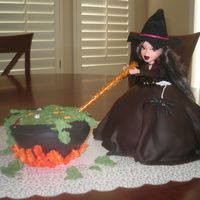 Halloween Witch doll cake covered in fondant. Cauldron is a half a sports ball pan covered in fondant with fondant eyeballs and nasty things.