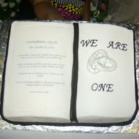 We Are One The words are on edible paper, the book mark is MMF, the rings are royal icing with silver luster dust, border is buttercream and the pages...