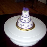 Three Tier Mini This miniture wedding cake was covered in fondant and accented with royal icing
