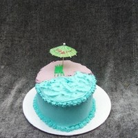 The Beach This is my first cake I have ever done. I am only 9 and I have never had a class. I used BC icing. I used a number 3 tip for the towel. The...