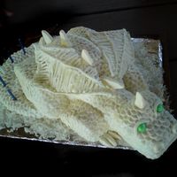 The White Dragon This is a white dragon that I made for my son's 5th birthday. It is white cake covered in MMF and painted with pearl dust. It was made...
