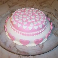 Pink Hearts - Fondant - First Time - No Class Taken This is a single layer 6 & 8 inch stacked yellow cake. I used white & pink fondant for the base. Heart & an Icing Tip (round...