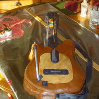 Guitar Hero For my grandson's 8th Birthday. White cake. All decoration is fondant. I traced his Guitar Hero guitar, so this is life size