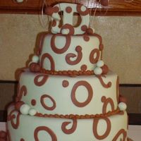 Trisha This cake was inspired by alot of cakes here. The colors were a light/sage green and chocolate brown. The topper is actually a wooden...
