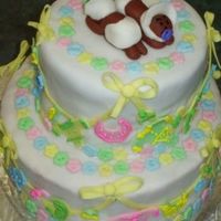 Tiiered Cake For Twins This is a tiered cake with baby clothes on the "line" and twins on top. Flower "buttons" adorn the top and bottom of...