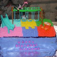 Playground Cake This cake features the playground interlocking mat with a swing, a slide and a picnic table. All done in buttercream (excluding the toys...