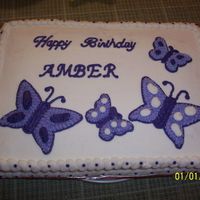 Purple Butterflies purple buttercream butterflies, on white buttercream covered chocolate cake