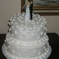 Aniversary Cake This cake was made for a 40th aniversary party. All buttercream. The doves and ring were part of the couple's wedding cake.