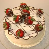 Strawberry Cake strawberry cake with filling and chocolate covered strawberries for a garnish