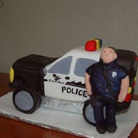 Police 10 inch square pan cut in half for the car. wheels are ding dongs covered in fondant. Police officer is made of fondant