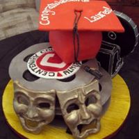 Film School Grad Film reels and Camera with cap. Reel spools and masks are modeling chocolate.