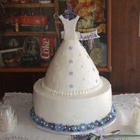 Bridal Shower Cake 4-layer 12" round with royal icing flowers on the bottom. Top is made from Wilton's doll cake pan. Bodice cut from fondant. Royal...