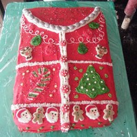 Ugly Christmas Sweater Cake Iced in buttercream, inside the cake was green and red vanilla swirl with whipped peppermint filling! Decorated with royal icing decor,...