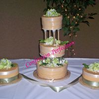 Ribbon Parade Iced in dark Ivory ButtercreamThere are 3 ivory ribbons on each of the center tiers. On the side cakes there are ivory ribbons on top and...