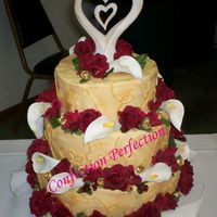 Midas Touch Iced in Dark Ivory ButtercreamButter cream dot accensts on sidesSilk FlowersLuster dust applied to the entire cake