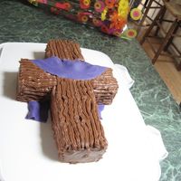 Cross Hot Fudge Buttercream icing(recipe from this site) with a fondant swag.