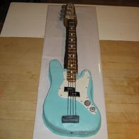 Fender Bass Guitar Carved from a 12x18 inch pan...chocolate cake iced in Buttercream with Fondant accents. Spaghetti used for strings. Thanks so much to...