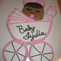 Baby Carriage This cake was made from one 12 inch round pan and three 6 inch round pans. I carved the carriage body from the 12 inch cake and then used...