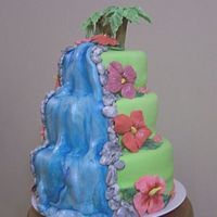 Luau_Cake.jpg This was for my best friend's daughter's graduation party. The flowers and trees were gumpaste, the rest was fondant. I also made...