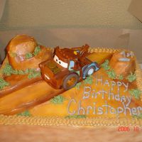 Tow Mater Tow mater on the dust road. buttercream that is airbrushed and cupcake hills. Tow Mater is a purchased toy.