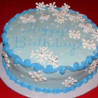 Winter Birthday Birthday cake for a lady whose birthday is the week before Christmas. Cake is iced in buttercream. Snowflakes are royal icing with dragees...