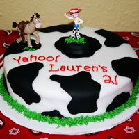 Yahoo Cowgirl! white fondant with black spots, buttercream grass border and writing