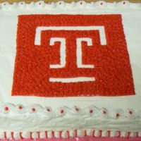 University Logo Cake I made this cake for my friend's husband that got his PHD.It is a half sheet cake frosted in butter cream. The top looks fine but the...