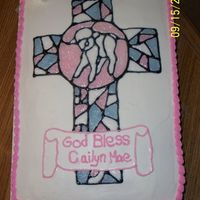 100_0911.jpg Buttercream icing, cross made with piping gel. Got this idea from "LittleMom; Thanks!