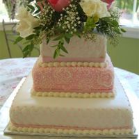 Gwynne's Wedding Cake I like the way this turned out but if anyone could tell me how to get my cakes to turn out perfect on the corners please let me know.