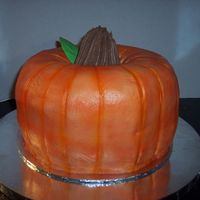 Pumpkin Cake Pumpkin made from 2 bundt cakes; Butter & German Chocolate. Iced in BC then airbrushed, drinking straw used to make indentions, ice...