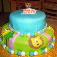 First Birthday This was the hardest cake I've ever done. The weird little monkey guy on top fell apart when I got it to the customer's house....