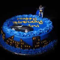 Batman! This was a birthday cake for the son of a friend. Buttercream icing with fondant buildings and plastic figure and car. Inspiration from...