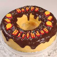 Donut Birthday cake combining two of the birthday boy's favorite childhood memories, donuts and candy birthday cake decorations.